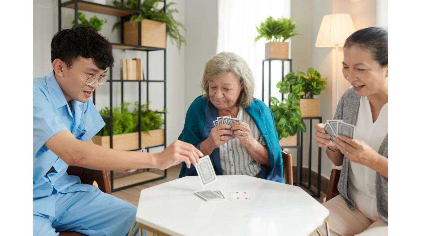 Nurse playing card with dementia patients in the dementia care facility